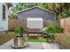 Backyard with patio seating, an outdoor shed, plants, and a stainless steel fire pit at 3008 N 13Th St, Tampa, FL 33605