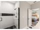 Modern bathroom with black and white tiles, a glass shower and an open door to the bedroom at 3008 N 13Th St, Tampa, FL 33605