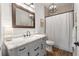 Updated bathroom with shiplap walls, modern vanity, bronze mirror, and a chandelier at 3008 N 13Th St, Tampa, FL 33605