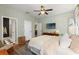 Comfortable bedroom featuring hardwood floors, a ceiling fan, and neutral tones for a relaxing atmosphere at 3008 N 13Th St, Tampa, FL 33605