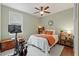 A beautifully staged bedroom with a ceiling fan, a window, and a stationary bike at 3008 N 13Th St, Tampa, FL 33605
