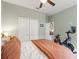 A well-lit bedroom featuring neutral walls, double closets, and a stationary bike at 3008 N 13Th St, Tampa, FL 33605