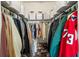 Walk-in closet with multiple clothing racks, overhead storage baskets, and built-in shoe shelves at 3008 N 13Th St, Tampa, FL 33605