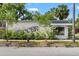 Charming storefront with vibrant greenery and artistic signage, creating an inviting and unique curb appeal at 3008 N 13Th St, Tampa, FL 33605
