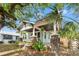 Charming craftsman-style home featuring a covered front porch with brick pillars and lush landscaping at 3008 N 13Th St, Tampa, FL 33605