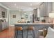 Open kitchen with gray cabinetry, granite countertops, and a breakfast bar, ideal for modern living at 3008 N 13Th St, Tampa, FL 33605