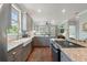 Open kitchen with granite countertops, stainless appliances, and a view into the adjacent living area at 3008 N 13Th St, Tampa, FL 33605