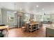 Open concept kitchen with stainless steel appliances, granite countertops, and an eat-in area at 3008 N 13Th St, Tampa, FL 33605