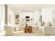 Open-concept living room and kitchen area, bright natural light, and stylish, comfortable furnishings at 31826 Griffin Sands Ln, San Antonio, FL 33576