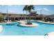 Resort-style pool surrounded by palm trees and comfortable lounge chairs, creating a relaxing oasis at 31826 Griffin Sands Ln, San Antonio, FL 33576