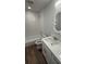 Renovated bathroom featuring new flooring, vanity, mirror and tiled shower/tub at 3188 Lake Saxon Dr, Land O Lakes, FL 34639