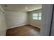 Bedroom with new vinyl floor, window, closet, base trim, and fresh neutral paint at 3188 Lake Saxon Dr, Land O Lakes, FL 34639