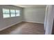 Bedroom with new vinyl floor, window, base trim, and fresh neutral paint at 3188 Lake Saxon Dr, Land O Lakes, FL 34639