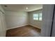 Bedroom featuring new flooring, a closet and light neutral paint throughout at 3188 Lake Saxon Dr, Land O Lakes, FL 34639