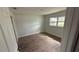 Bedroom featuring new flooring, a large window and light neutral paint throughout at 3188 Lake Saxon Dr, Land O Lakes, FL 34639