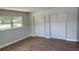 Bedroom with vinyl floors, fresh paint, window and closet at 3188 Lake Saxon Dr, Land O Lakes, FL 34639