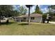 Charming single-story home featuring a well-maintained lawn and mature landscaping at 3188 Lake Saxon Dr, Land O Lakes, FL 34639