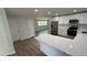 Open kitchen with stainless appliances, stone countertops, and lots of natural light at 3188 Lake Saxon Dr, Land O Lakes, FL 34639