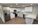 Bright kitchen featuring white cabinets, stainless steel appliances, and quartz countertops at 3188 Lake Saxon Dr, Land O Lakes, FL 34639