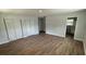 Open living room with new flooring, three closets and light neutral paint throughout at 3188 Lake Saxon Dr, Land O Lakes, FL 34639