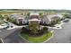 Community clubhouse featuring lush landscaping, ample parking, and a welcoming entrance at 32062 Griffin Sands Ln, San Antonio, FL 33576