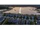 Stunning aerial view of a well-planned community featuring beautiful homes, a serene lake, and landscaped streets at 3303 Monroe Meadows Dr, Odessa, FL 33556