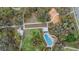 Aerial view of community amenities, including a pool, playground, walking paths, and green spaces at 3303 Monroe Meadows Dr, Odessa, FL 33556