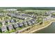 Expansive aerial view of a new residential development with lush landscaping, recreational fields, and a serene lake at 3303 Monroe Meadows Dr, Odessa, FL 33556