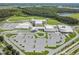 Aerial view of school featuring a football field and a large parking area at 3303 Monroe Meadows Dr, Odessa, FL 33556