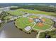Aerial view of baseball fields, tennis courts, lakes and parking lots in a recreational area at 3303 Monroe Meadows Dr, Odessa, FL 33556
