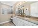 Bright bathroom featuring double vanity with marble countertop and a glass door shower at 3303 Monroe Meadows Dr, Odessa, FL 33556