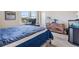 A cozy bedroom with hardwood floors, and a dresser with an aquarium at 3303 Monroe Meadows Dr, Odessa, FL 33556