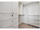 Walk-in closet with built-in shelving, drawers, and hanging rods for organized storage at 3303 Monroe Meadows Dr, Odessa, FL 33556