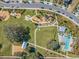 Aerial view of a community park with a modern playground, pool, and recreational area at 3303 Monroe Meadows Dr, Odessa, FL 33556