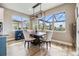 Light-filled dining area with stylish chandelier, views of the outdoor pool, and modern furnishings at 3303 Monroe Meadows Dr, Odessa, FL 33556