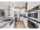 Modern kitchen with stainless steel appliances, granite countertops, and stylish cabinetry at 3303 Monroe Meadows Dr, Odessa, FL 33556