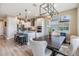 An open kitchen flows into a modern dining space complete with an island with barstool seating at 3303 Monroe Meadows Dr, Odessa, FL 33556