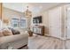 Cozy living room with neutral tones, plush seating, and modern lighting fixtures at 3303 Monroe Meadows Dr, Odessa, FL 33556