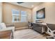 Modern office space featuring a desk, and sofa. The room offers natural light and functional workspace at 3303 Monroe Meadows Dr, Odessa, FL 33556