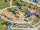Overhead view of a modern playground featuring a slide, climbing structure, and landscaping at 3303 Monroe Meadows Dr, Odessa, FL 33556