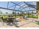 The screened patio features a dining area and comfortable seating, perfect for outdoor entertaining at 3303 Monroe Meadows Dr, Odessa, FL 33556