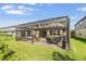 Well-kept backyard and covered patio offers ideal outdoor entertaining space at 3303 Monroe Meadows Dr, Odessa, FL 33556