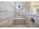Modern shower featuring stylish tilework, built-in bench, and rainfall shower head at 3303 Monroe Meadows Dr, Odessa, FL 33556