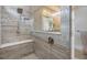 Nicely tiled glass shower area with a bench, shower head, and a clear glass partition at 3303 Monroe Meadows Dr, Odessa, FL 33556