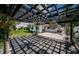 Landscaped backyard with pergola, grass, plants, and outdoor lighting at 333 Belleair Ne Dr, St Petersburg, FL 33704