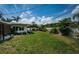A backyard with a well kept lawn, plants, and privacy fence is perfect for outdoor entertaining and relaxation at 333 Belleair Ne Dr, St Petersburg, FL 33704