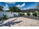 Lush backyard with covered pergola and a white privacy fence at 333 Belleair Ne Dr, St Petersburg, FL 33704