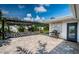 Charming backyard patio with pergola, lush greenery, and barbecue grill at 333 Belleair Ne Dr, St Petersburg, FL 33704