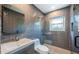 Modern bathroom with gray tiled walls, glass shower, and sleek vanity at 333 Belleair Ne Dr, St Petersburg, FL 33704