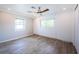 Bedroom features neutral tones, wood floors, a ceiling fan, and lots of natural light at 333 Belleair Ne Dr, St Petersburg, FL 33704
